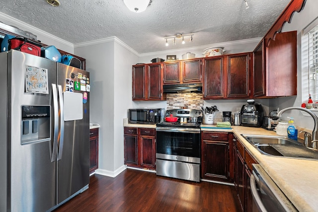 kitchen featuring sink, stainless steel appliances, crown molding, dark wood-type flooring, and a textured ceiling