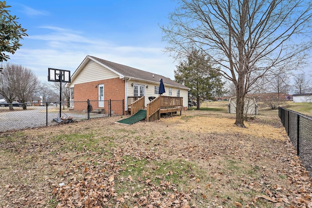 rear view of property featuring a wooden deck