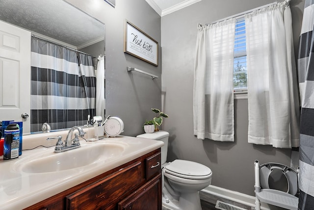 bathroom featuring ornamental molding, vanity, and toilet