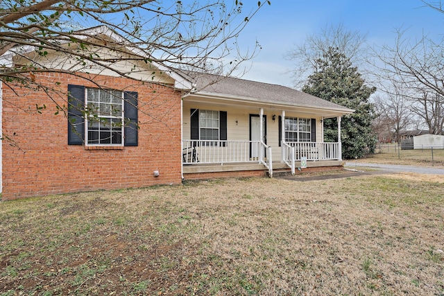 single story home with a front yard and a porch