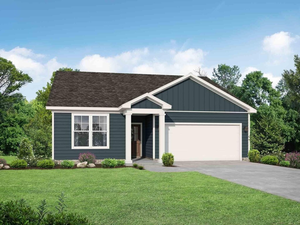 view of front of property with a garage and a front lawn