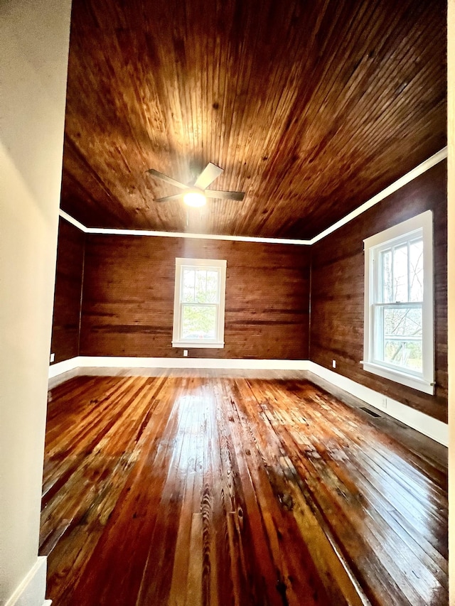 additional living space with hardwood / wood-style floors, plenty of natural light, and wooden ceiling