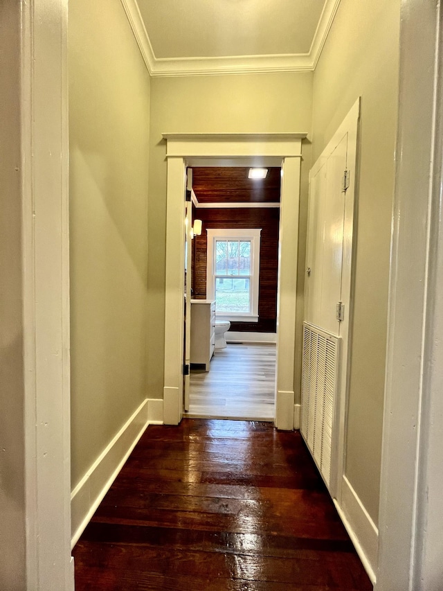 hall with ornamental molding and dark hardwood / wood-style flooring