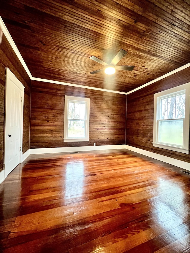 unfurnished room featuring crown molding, hardwood / wood-style flooring, and a wealth of natural light