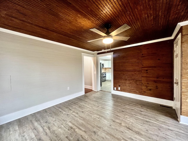 spare room featuring hardwood / wood-style flooring, ceiling fan, and wooden ceiling