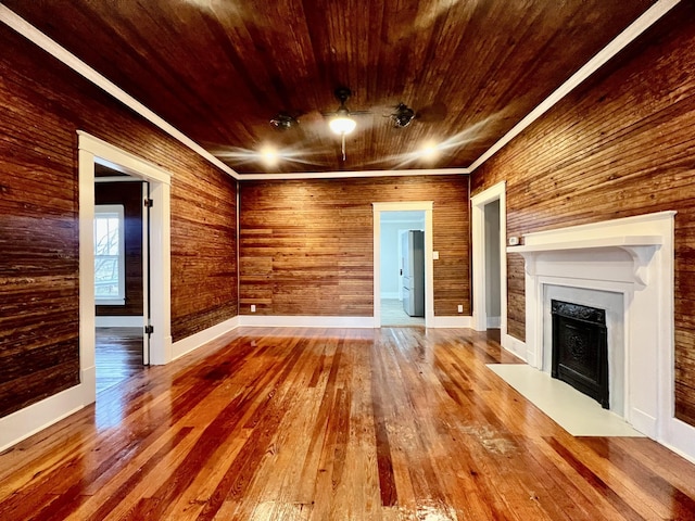 unfurnished living room featuring hardwood / wood-style flooring and wooden ceiling