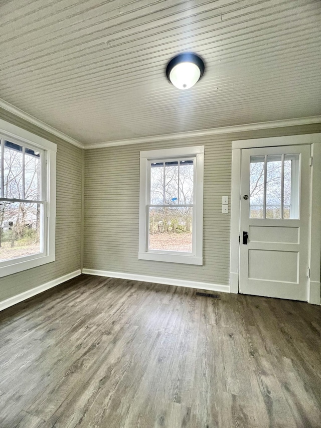 entryway featuring crown molding, plenty of natural light, and hardwood / wood-style floors