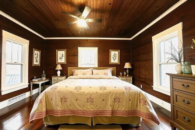 bedroom featuring dark hardwood / wood-style flooring, ceiling fan, and wood ceiling