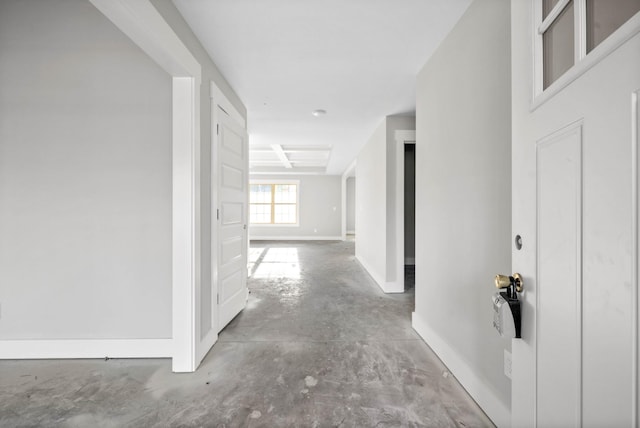 hall with concrete flooring