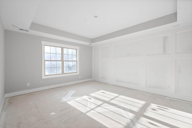 spare room with a raised ceiling