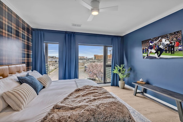 635 7th Ave S Unit 211, Nashville, TN 37203 - bedroom featuring ornamental molding, wood finished floors, baseboards, and a ceiling fan