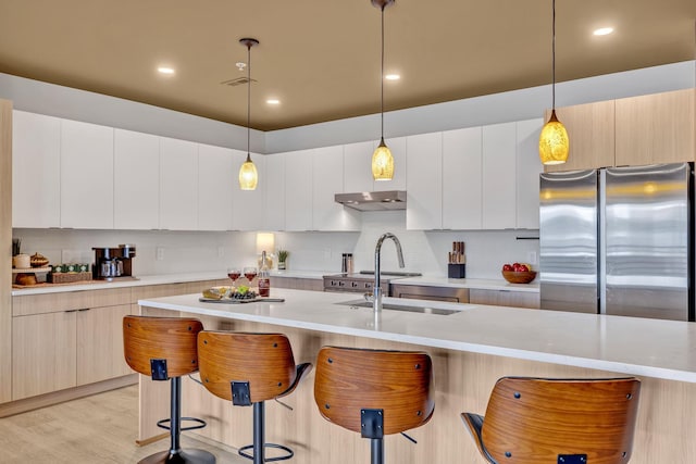 635 7th Ave S Unit 211, Nashville, TN 37203 - kitchen featuring freestanding refrigerator, a breakfast bar area, modern cabinets, light countertops, and recessed lighting