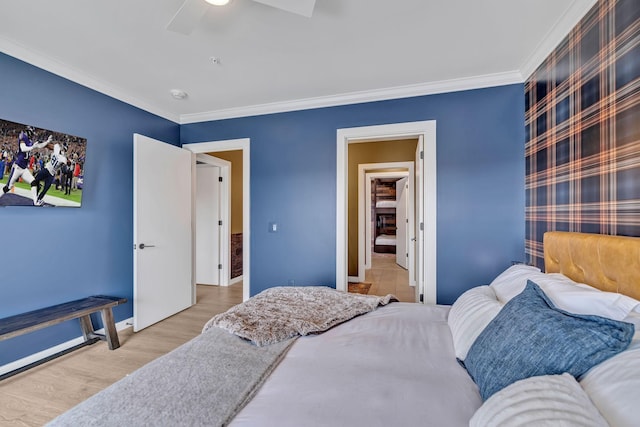 635 7th Ave S Unit 211, Nashville, TN 37203 - bedroom featuring crown molding, baseboards, wood finished floors, and a ceiling fan