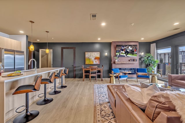 635 7th Ave S Unit 211, Nashville, TN 37203 - living room with recessed lighting and light wood-style floors