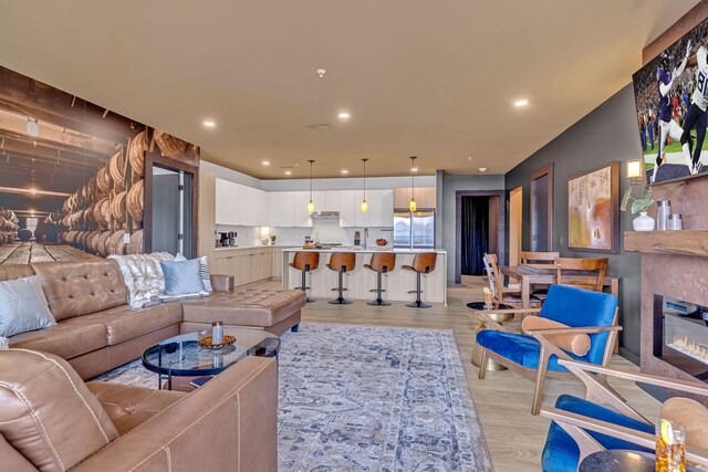 635 7th Ave S Unit 211, Nashville, TN 37203 - living room featuring light wood-type flooring, recessed lighting, and a glass covered fireplace