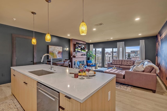 635 7th Ave S Unit 211, Nashville, TN 37203 - kitchen featuring a sink, stainless steel dishwasher, light brown cabinets, open floor plan, and modern cabinets