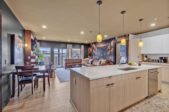 635 7th Ave S Unit 211, Nashville, TN 37203 - kitchen featuring a sink, modern cabinets, dishwasher, light wood-style flooring, and light countertops