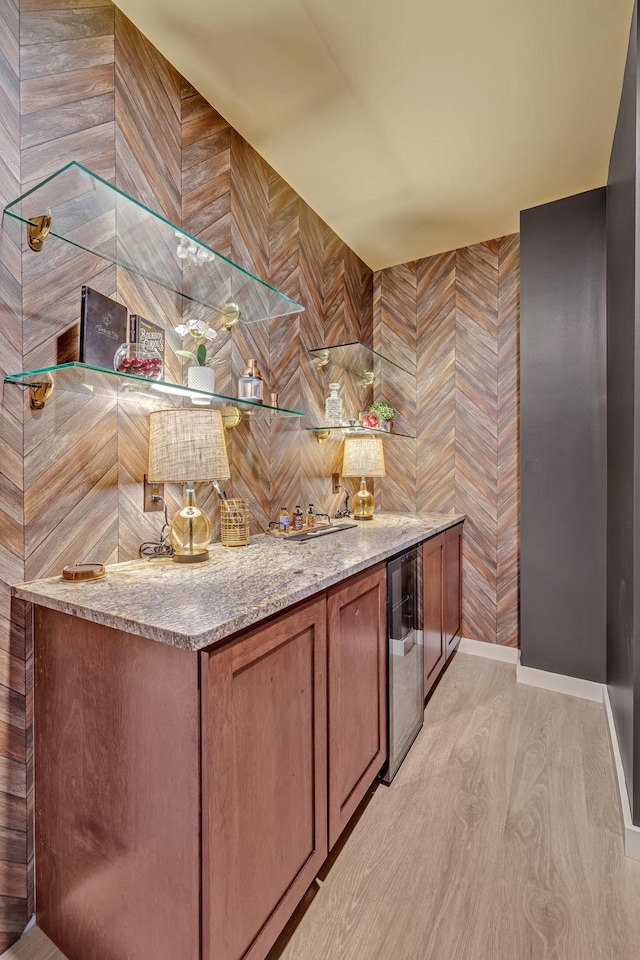 635 7th Ave S Unit 211, Nashville, TN 37203 - indoor dry bar featuring light wood-style floors, wine cooler, and baseboards