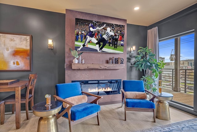 635 7th Ave S Unit 211, Nashville, TN 37203 - sitting room featuring a glass covered fireplace, wood finished floors, and recessed lighting