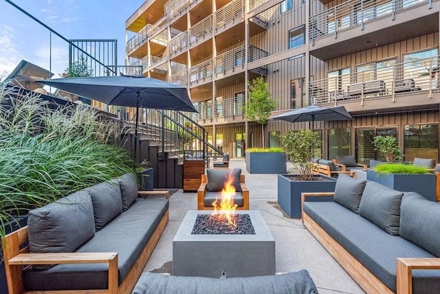 635 7th Ave S Unit 211, Nashville, TN 37203 - view of patio featuring an outdoor living space with a fire pit and stairs