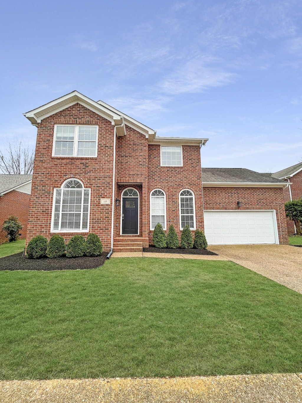 view of front of house featuring a garage and a front yard