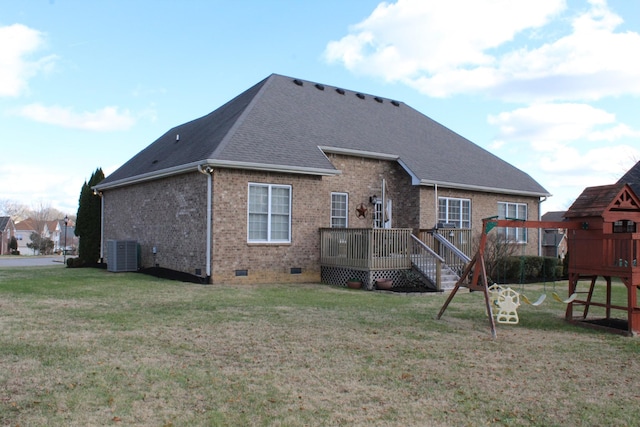 back of house featuring a playground, cooling unit, brick siding, a yard, and crawl space