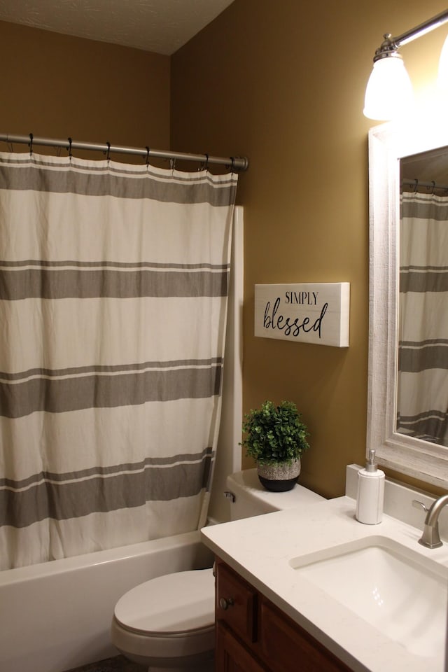 full bathroom with shower / bath combination with curtain, vanity, and toilet