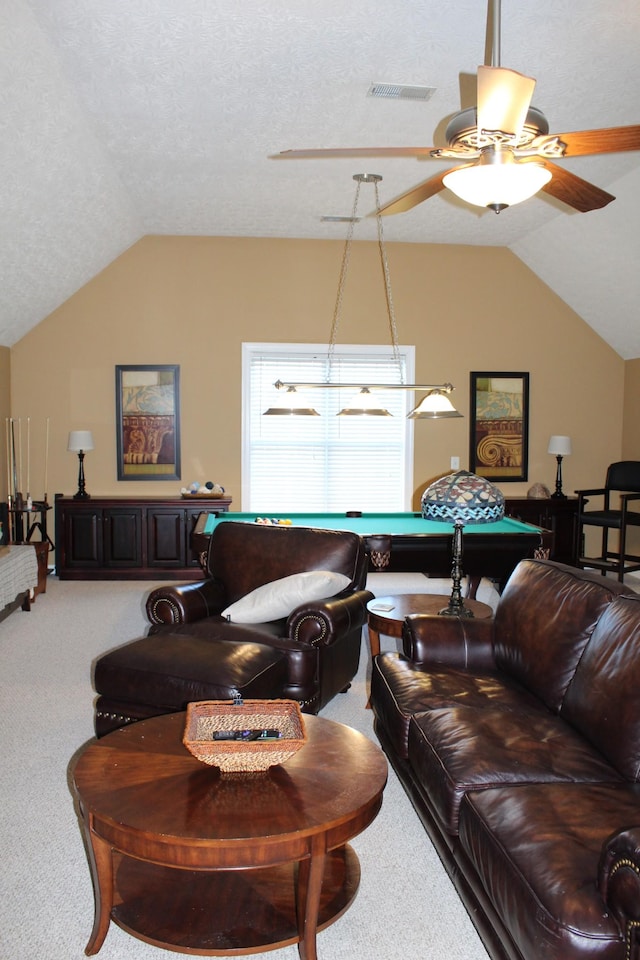 living area with vaulted ceiling, carpet flooring, visible vents, and a ceiling fan