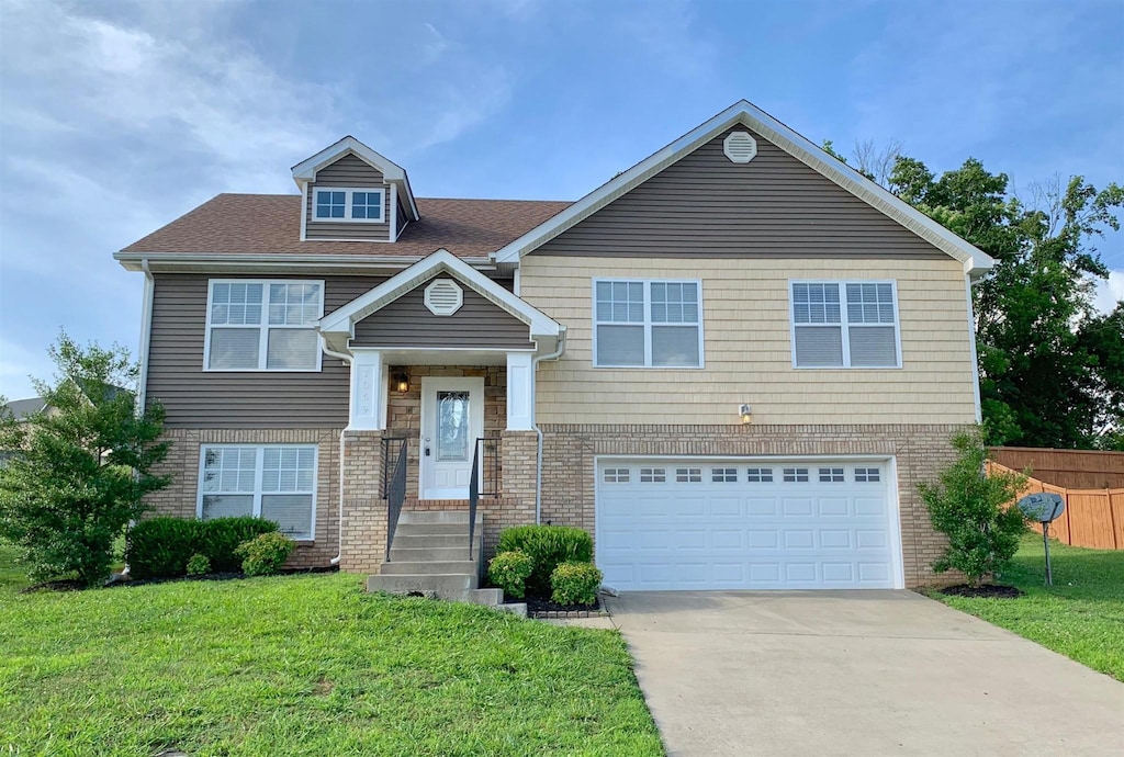 split foyer home with a garage and a front yard