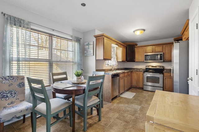 kitchen with sink, light tile patterned floors, and appliances with stainless steel finishes