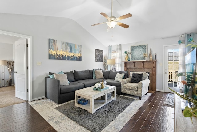 living room featuring ceiling fan, lofted ceiling, dark hardwood / wood-style floors, and a tile fireplace