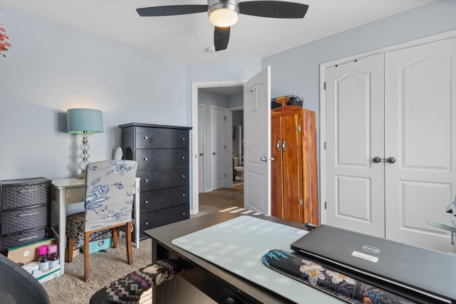 carpeted office featuring ceiling fan