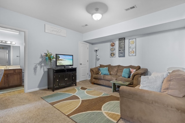 living room featuring light carpet and sink