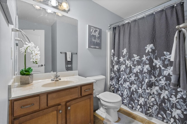 bathroom with vanity, toilet, and curtained shower