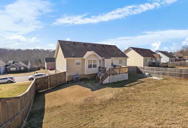 back of house with cooling unit, a yard, and a deck