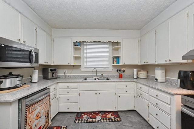 kitchen with extractor fan, sink, and white cabinets