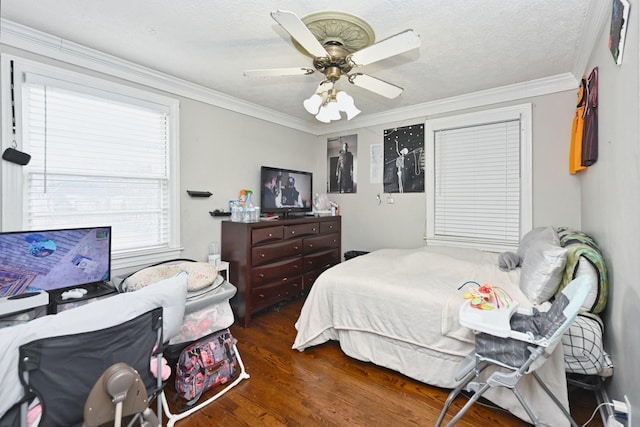 bedroom featuring a textured ceiling, ornamental molding, dark hardwood / wood-style floors, and ceiling fan