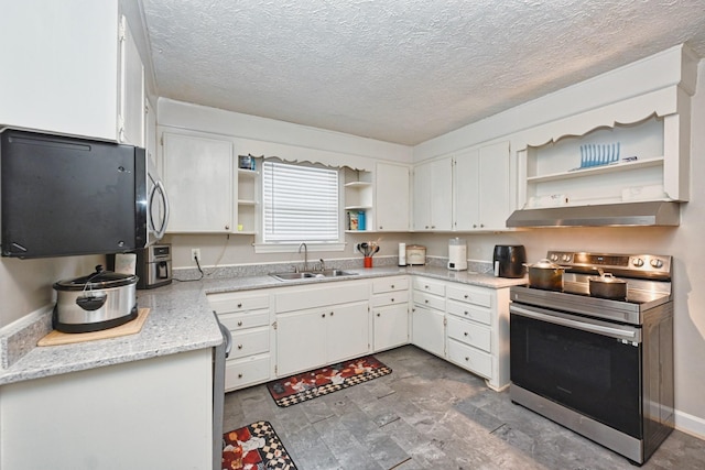 kitchen with sink, white cabinets, electric range, light stone countertops, and a textured ceiling