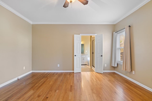 empty room featuring ceiling fan, ornamental molding, and light hardwood / wood-style floors