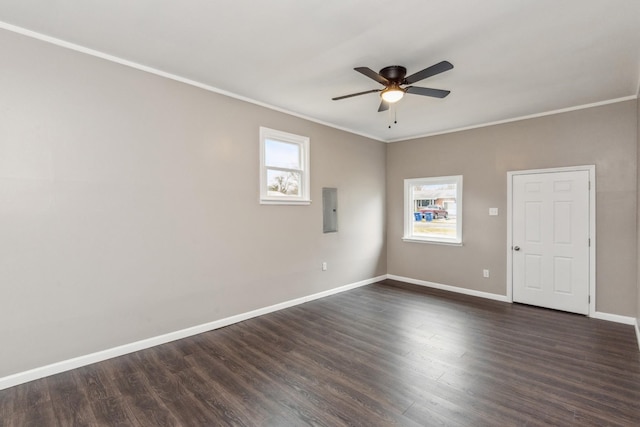 spare room with crown molding, electric panel, and dark hardwood / wood-style flooring