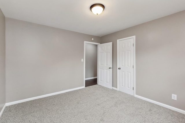 unfurnished bedroom featuring carpet flooring and a closet