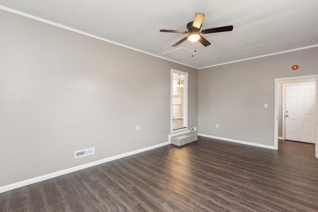 empty room featuring dark hardwood / wood-style flooring, crown molding, and ceiling fan