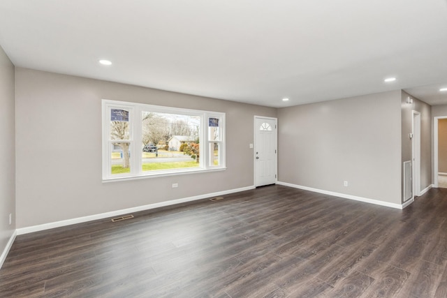 empty room featuring dark wood-type flooring