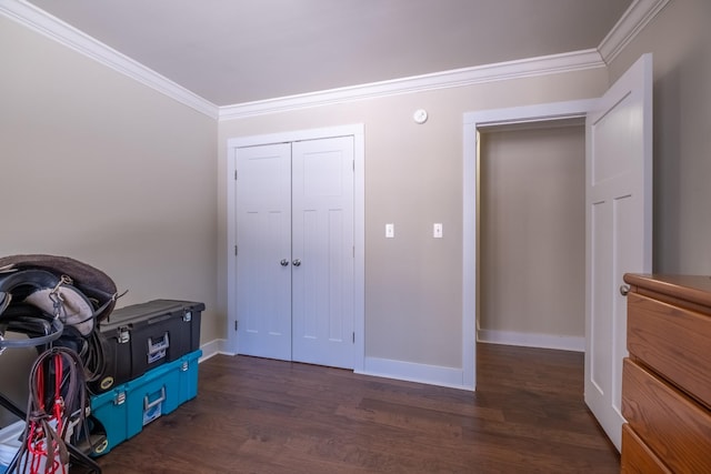 bedroom with crown molding, dark hardwood / wood-style flooring, and a closet