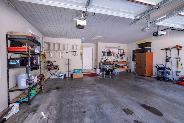 garage with a garage door opener and a workshop area