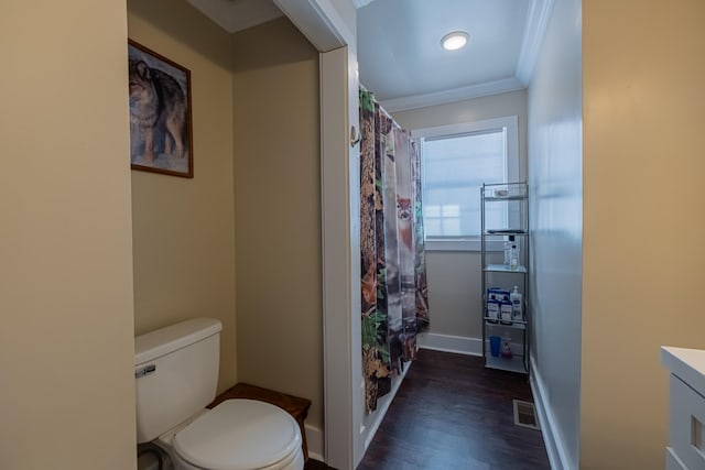 bathroom featuring vanity, hardwood / wood-style flooring, ornamental molding, and toilet