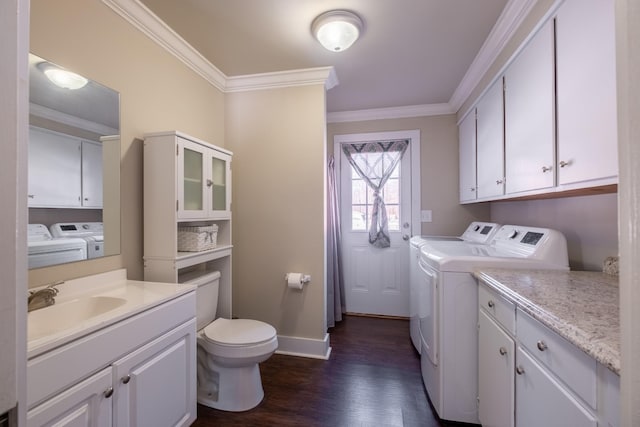 laundry room with crown molding, dark hardwood / wood-style floors, washer and clothes dryer, and sink