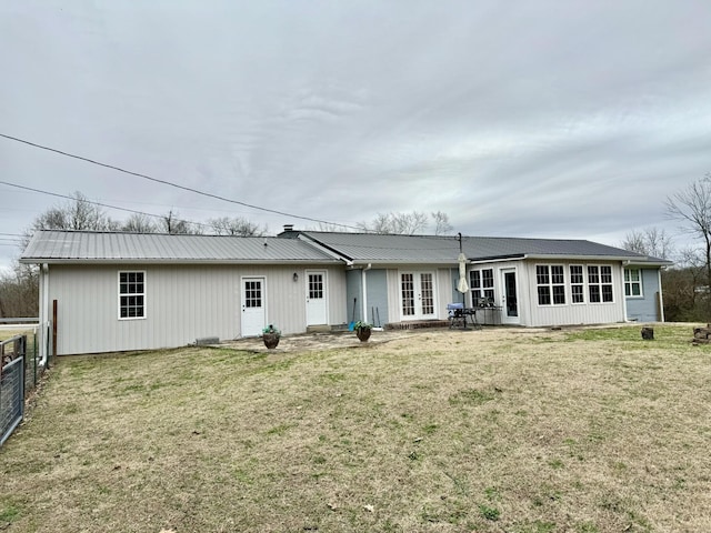 rear view of house with french doors, a yard, and a patio area