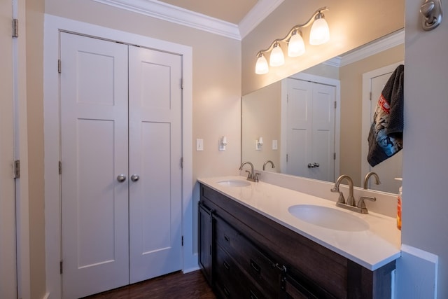 bathroom featuring vanity, crown molding, and wood-type flooring