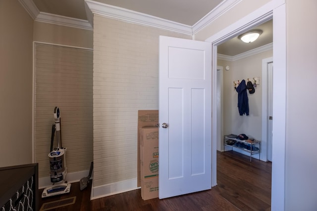 interior space with ornamental molding and dark hardwood / wood-style flooring